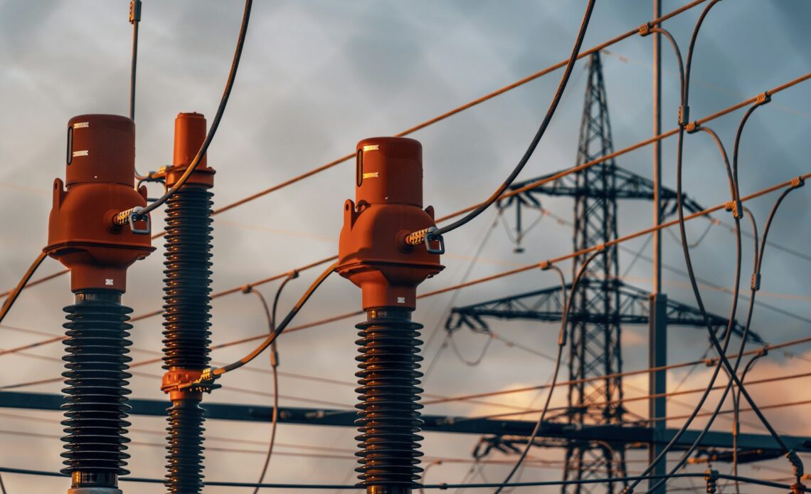 A row of power lines with a sky in the background