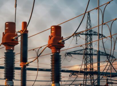 A row of power lines with a sky in the background