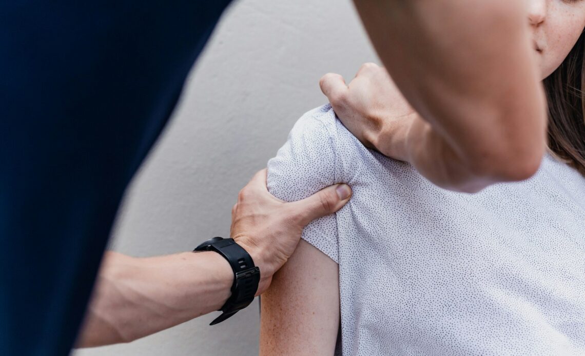 a woman holding onto a man's arm