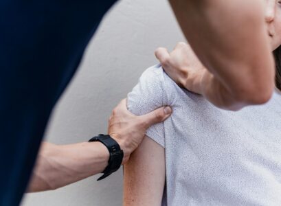 a woman holding onto a man's arm