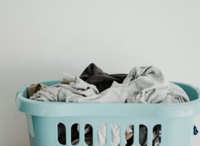 white textile on blue plastic laundry basket